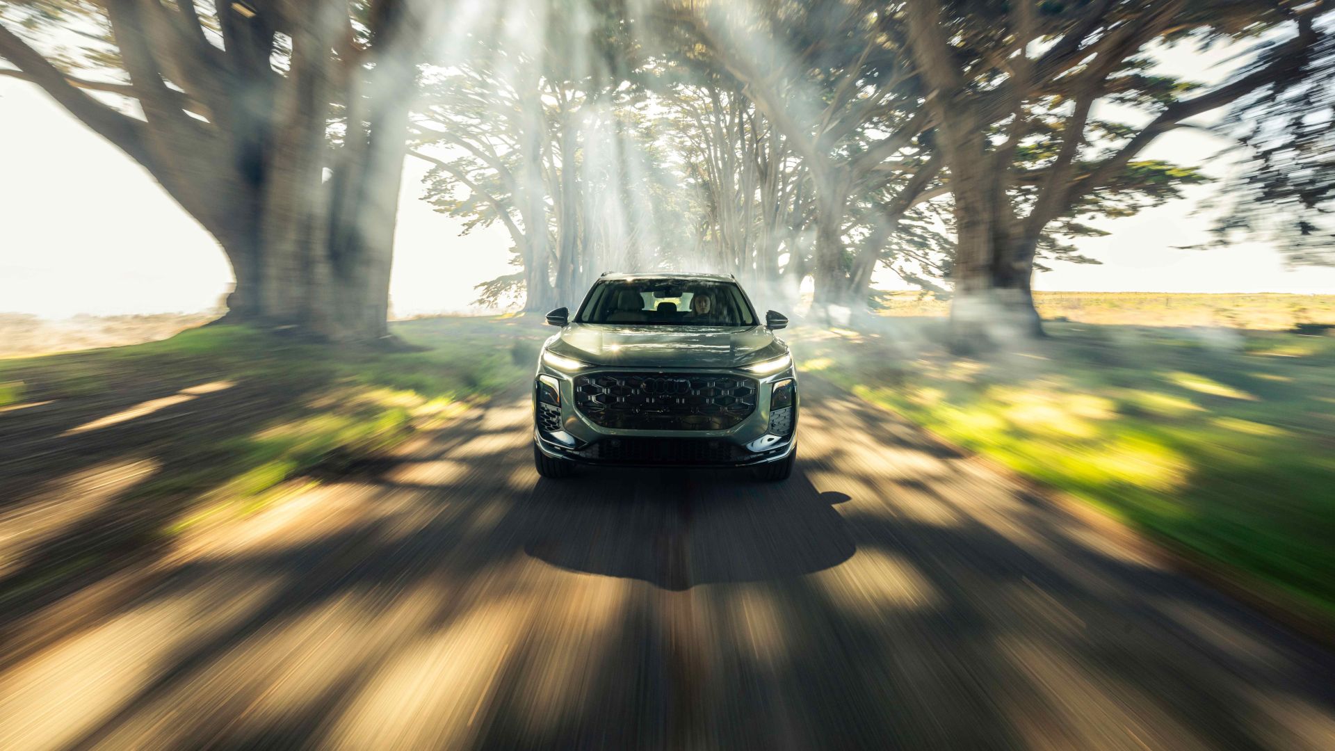 Audi Q3 accelerating, front profile view.
